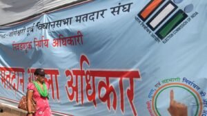 Mumbai: A pedestrian passes by a banner put up by the Election Commissioner urging citizens to cast their vote on the eve of the Maharashtra Assembly polls, in Mumbai, Tuesday, Nov. 19, 2024. (PTI Photo)(PTI11_19_2024_000339B)